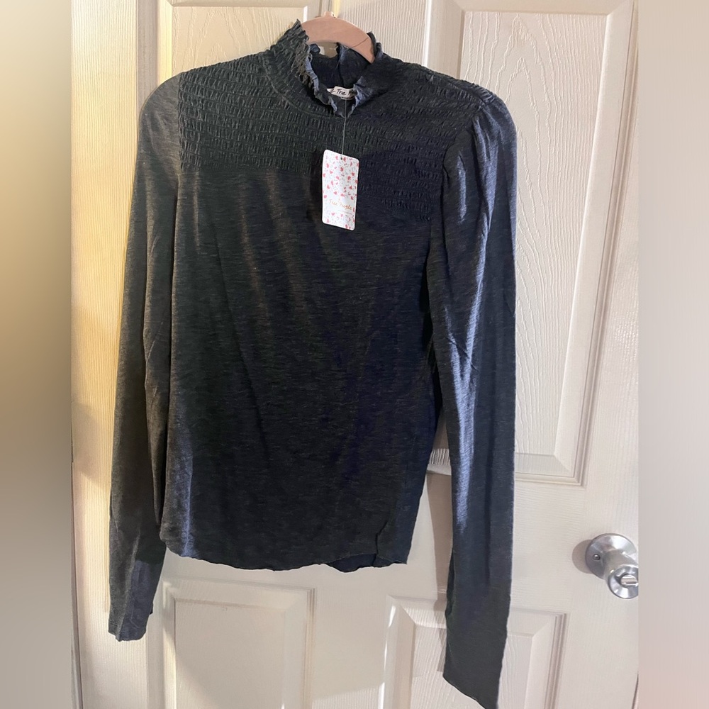 Free People casual and lite and very comfy. Super soft and black in color.